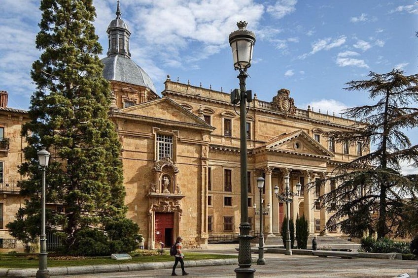 A historic building with a dome, columns, and a red door. 5