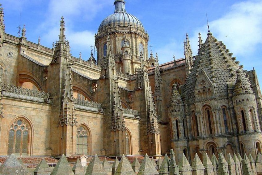 A historic cathedral with a large dome, intricate spires, and detailed stonework. 2