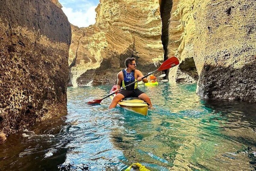 Une personne pratiquant le kayak dans un canyon étroit aux parois rocheuses. 2