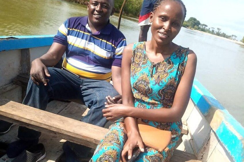 Zwei Personen sitzen in einem Boot, im Hintergrund fließt ein Fluss. 3