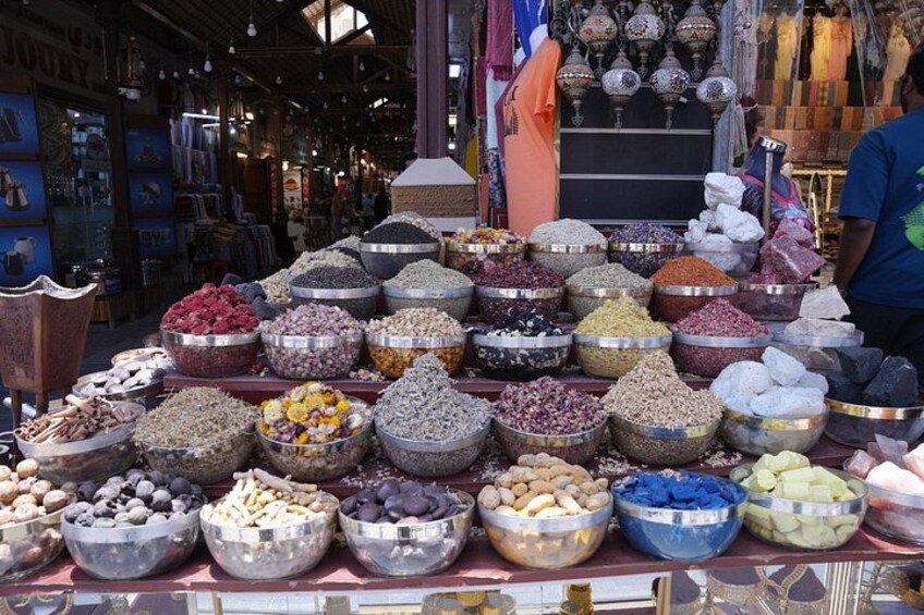 A market stall with various bowls of nuts and dried fruits. 3