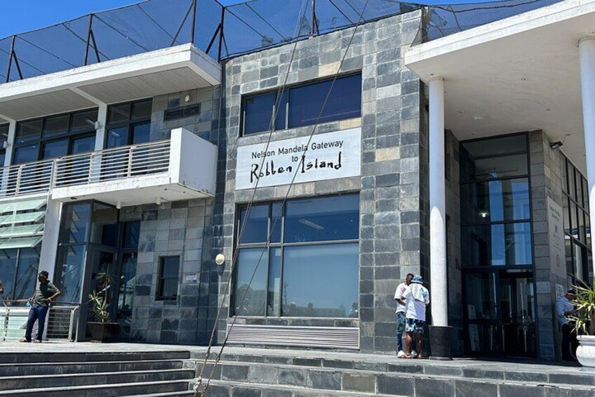 A modern building with a sign reading 'Nelson Mandela Gateway to Robben Island.' 3