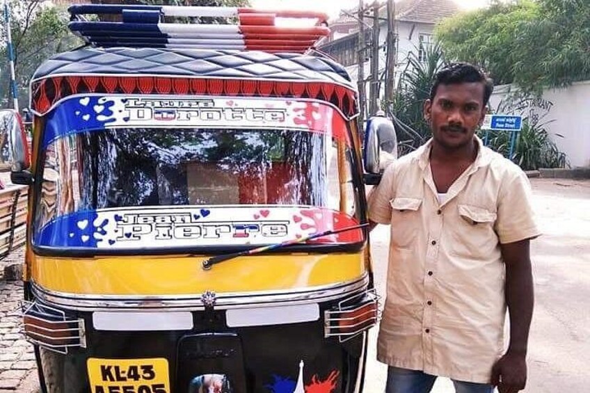 A yellow and red auto-rickshaw with a license plate KL43. 1