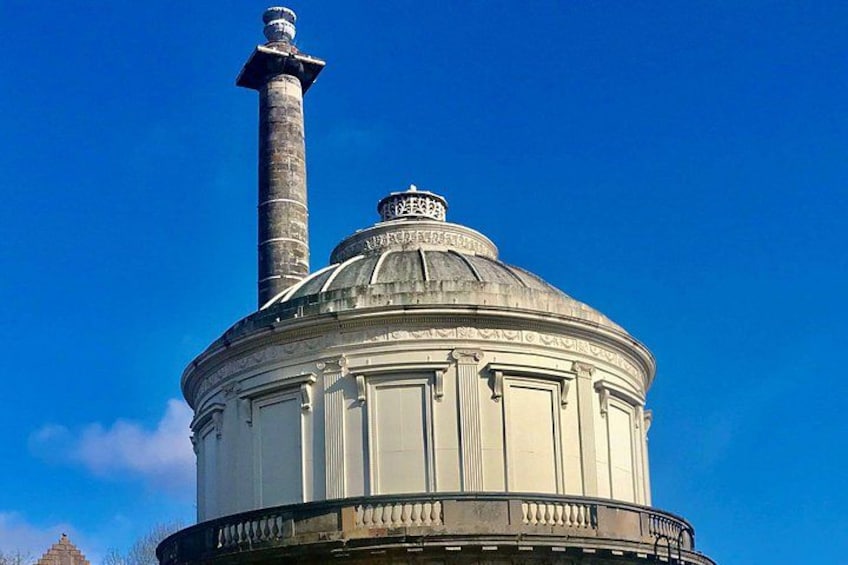 A domed building with a tall chimney and a statue on top. 3