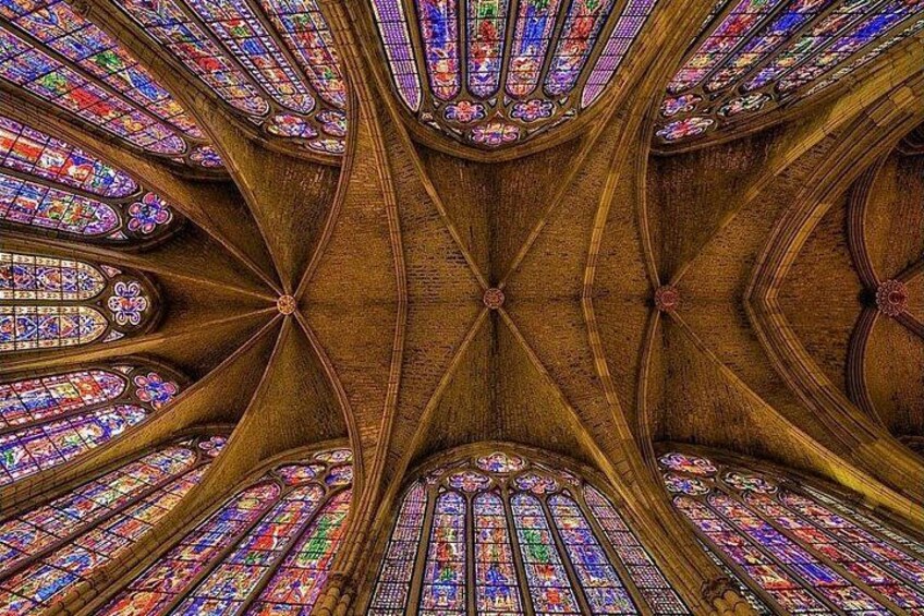 A cathedral ceiling with stained glass windows. 2