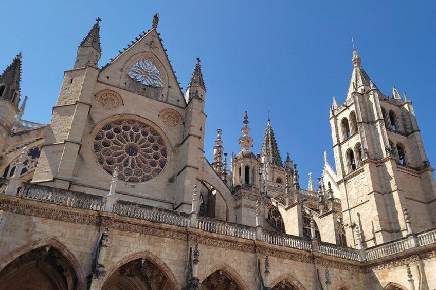 A Gothic cathedral with a large rose window, pointed arches, and multiple spires. 2
