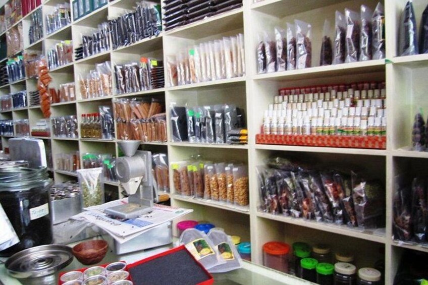 Shelves stocked with various packaged goods, including spices, grains, and other food items. 3