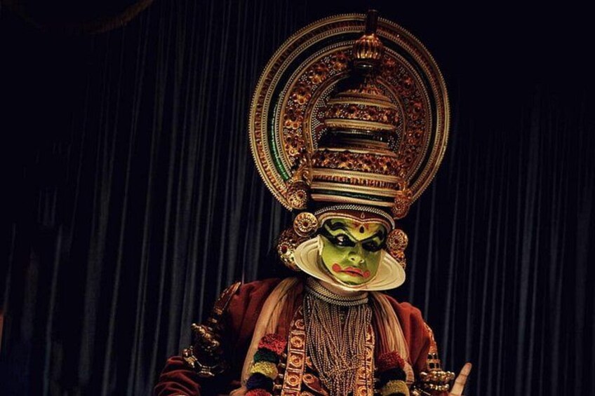 A person in traditional costume with elaborate headgear and jewelry. 5