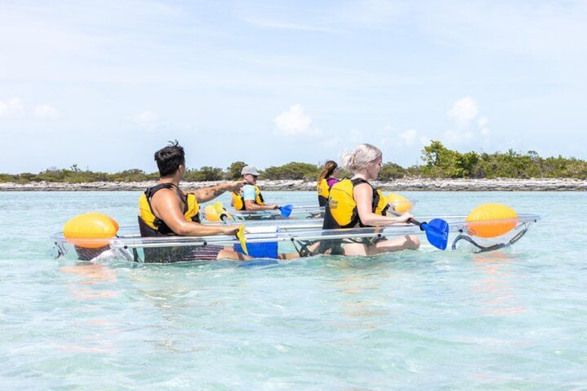 People rowing a boat in clear water. 4
