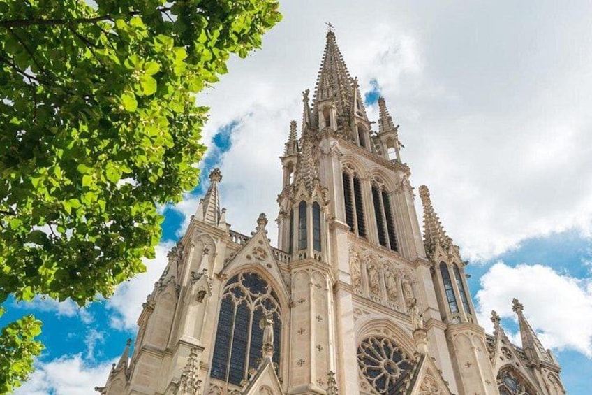A Gothic cathedral with intricate architecture, large stained glass windows, and a spire. 5