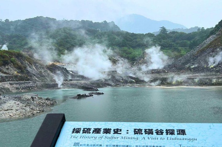 A sulfur mining site with steam vents and a body of water. 4