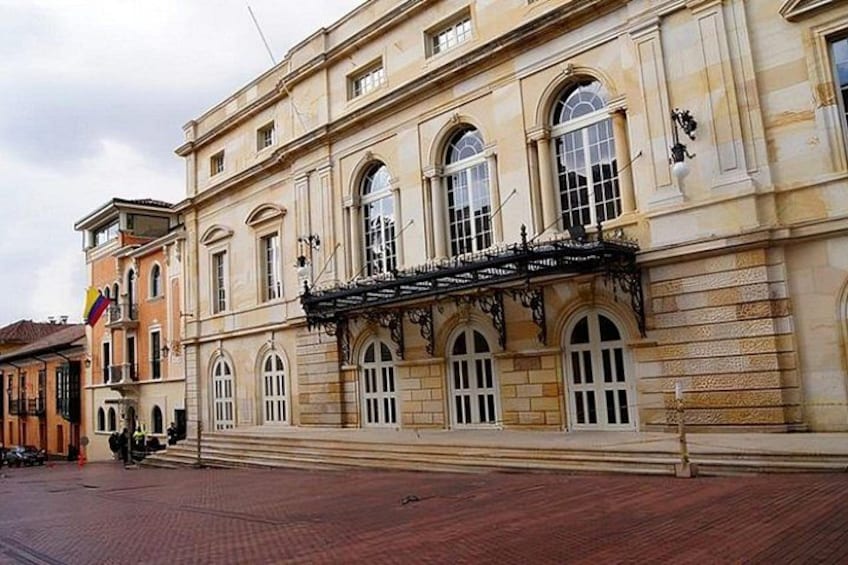 A historic building with arched windows and a balcony. 3