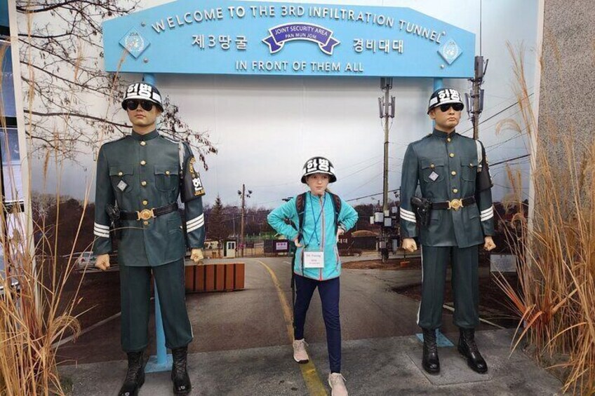 A sign with military figures and a person in civilian clothing. 1