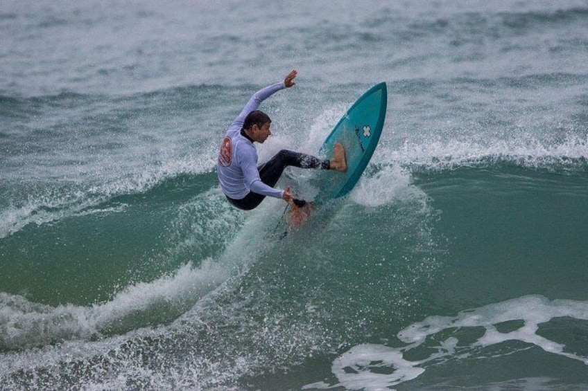 A person surfing on a wave in the ocean. 4