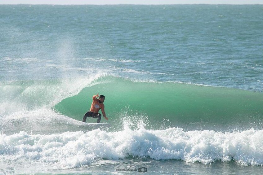 A person surfing a wave in the ocean. 3