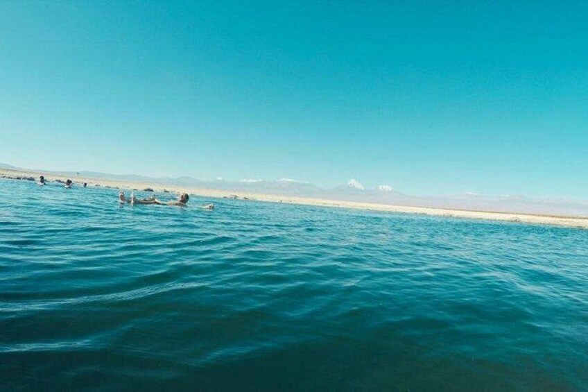 A calm sea with people swimming. 5