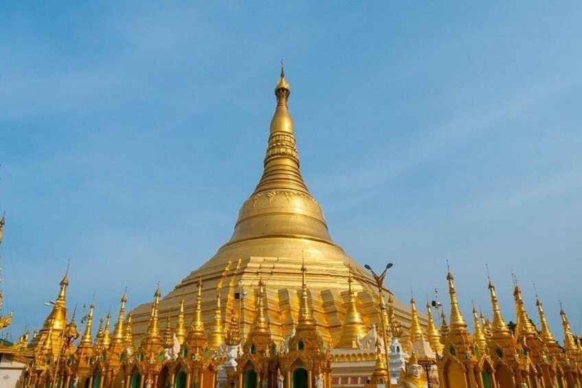 A large golden stupa surrounded by smaller golden structures. 1