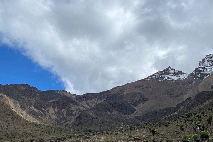 A mountainous landscape with a clear sky and a snow-capped peak. 5