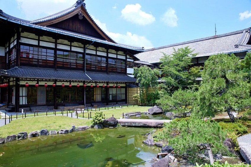 A traditional Japanese building with a pond and koi fish. 2