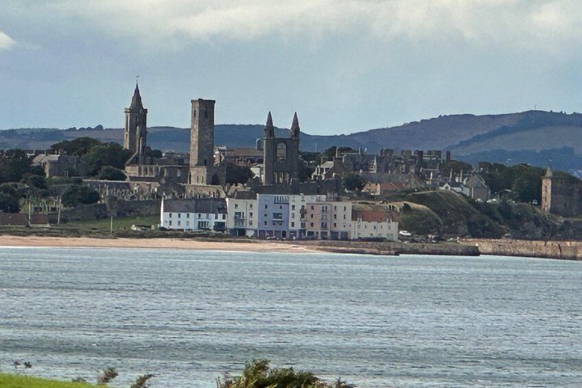 A coastal town with historic buildings, a beach, and a body of water. 5