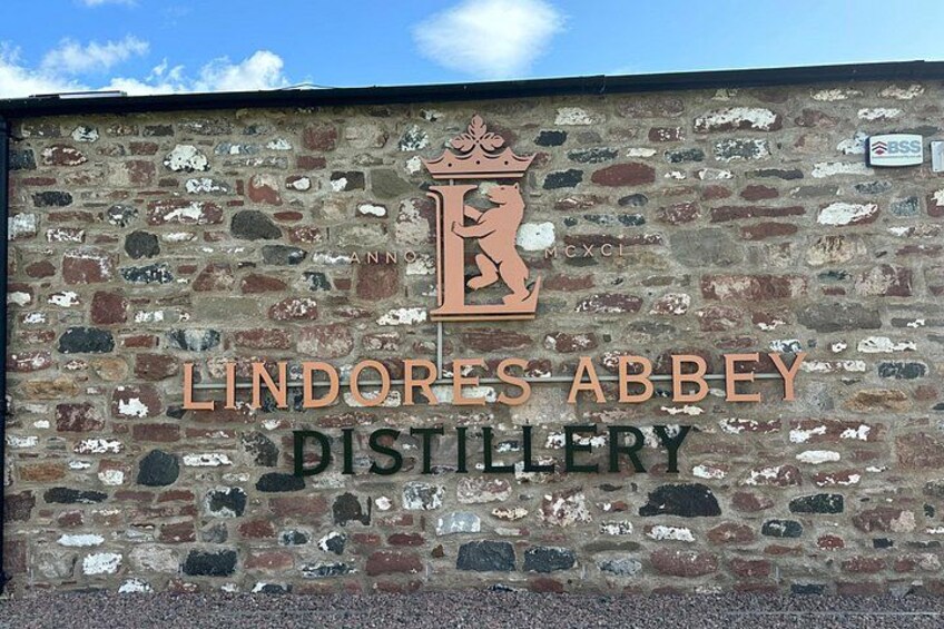 A brick wall with the Lindores Abbey Distillery logo and name. 3