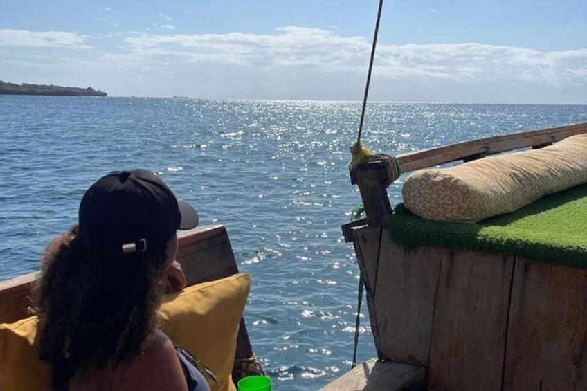 A person fishing on a boat with a view of the ocean. 3