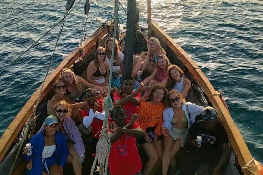 A group of people on a wooden boat on the water. 2