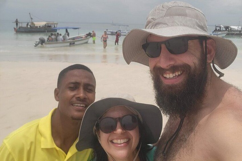 A beach with people, boats, and a clear sky. 5