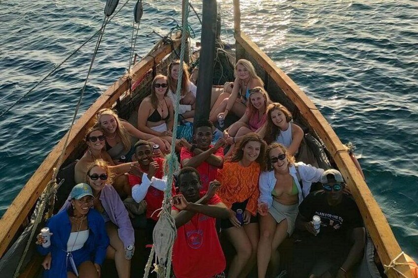 A group of people on a wooden boat on water. 2