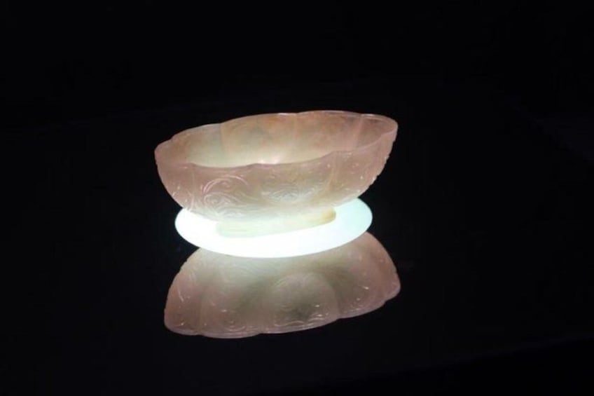 A translucent glass bowl on a reflective surface. 5