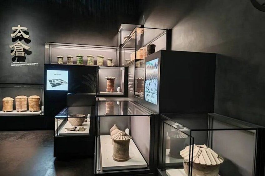 Eine Museumsausstellung mit Glasvitrinen, die Keramik und Artefakte zeigen. 3