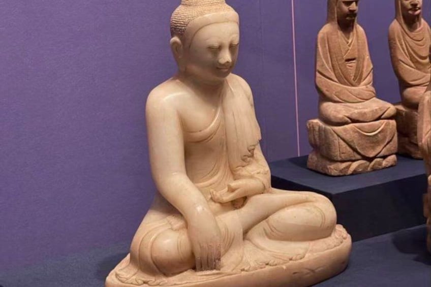 A seated Buddha statue in a meditative pose. 4