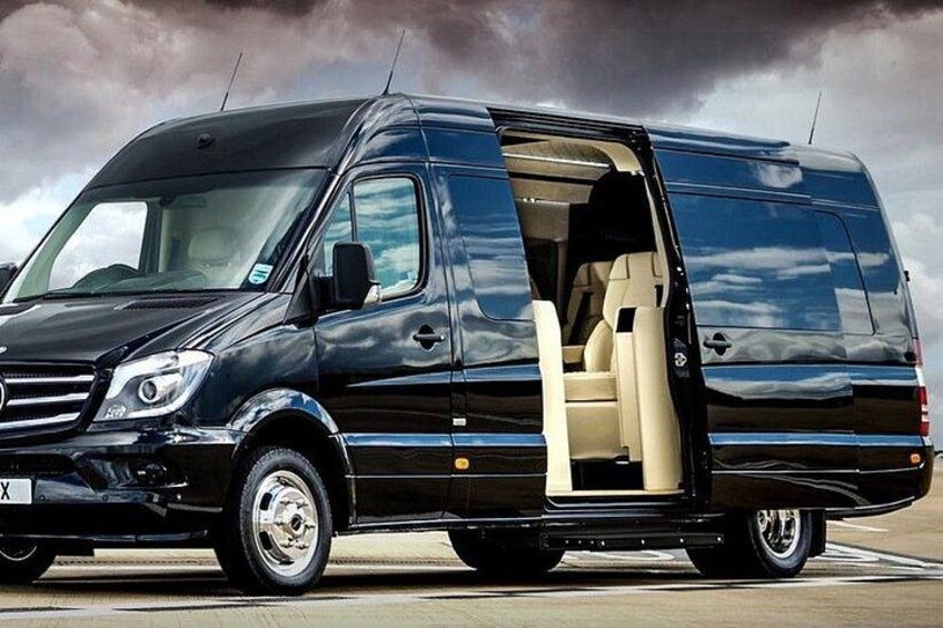 A black van with its door open, revealing the interior. 3