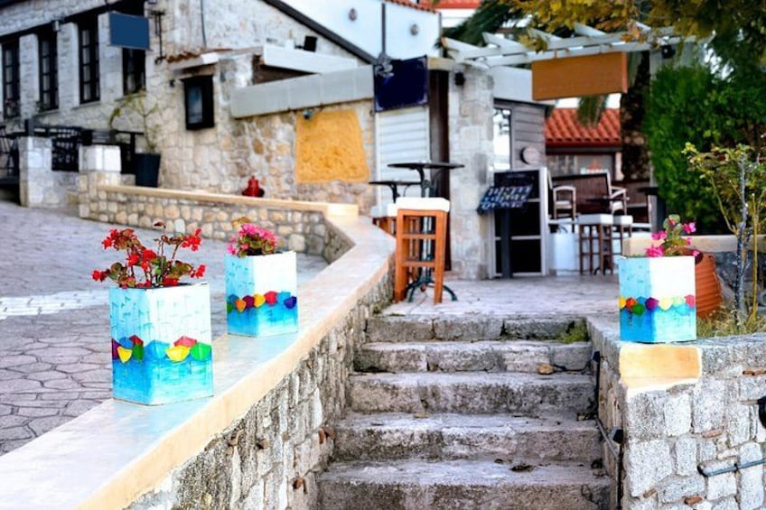 Outdoor seating with colorful planters and a stone staircase. 4