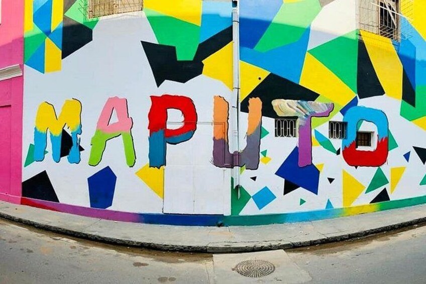 A colorful wall with the word 'MAPUTO' painted in large, multicolored letters. 4