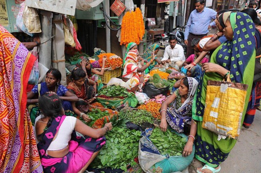 People selling vegetables at a market. 5