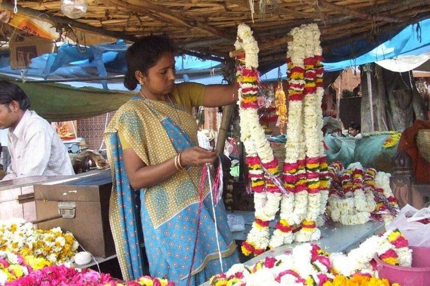 A woman arranging flower garlands. 1