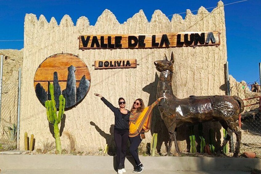 A sign for Valle de la Luna in Bolivia with a cactus and llama sculpture. 4