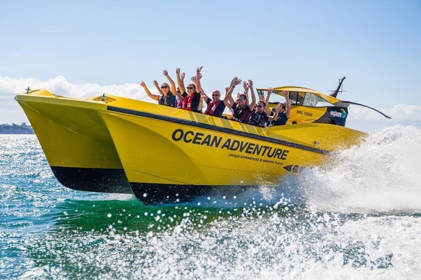 A yellow boat with 'OCEAN ADVENTURE' written on it, moving through water. 3
