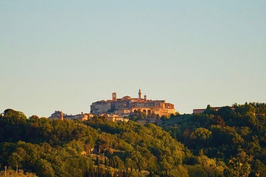 A historic building on a hilltop, surrounded by dense greenery. 4