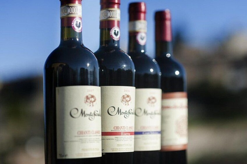 Four wine bottles with labels, arranged in a row. 3