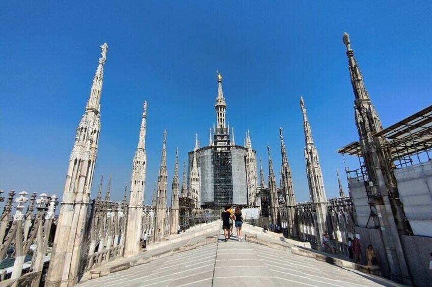 A grand cathedral with multiple spires and a central dome, viewed from a bridge. 5