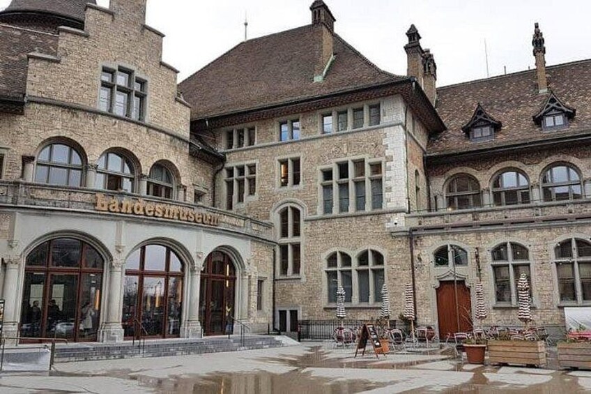 A historic building with arched windows and a sign that reads 'landesmuseum.' 1