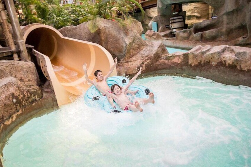 Un toboggan aquatique et une piscine où les gens s’amusent dans l’eau. 1