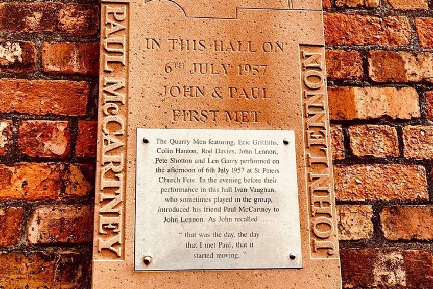 A plaque on a brick wall commemorating the first meeting of John Lennon and Paul McCartney at St. Peter's Church Fete on 6th July 1957. 2