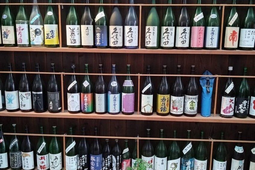 Shelves of various bottles with labels, likely containing different types of beverages. 5