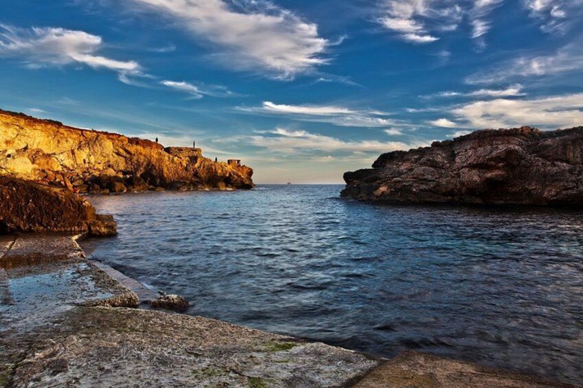 A coastal landscape with rocky cliffs and calm sea. 3