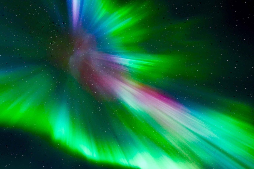 A starry night sky with vibrant green aurora lights. 3