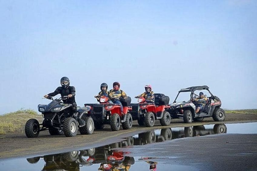 Four off-road vehicles on a muddy path with water puddles. 3