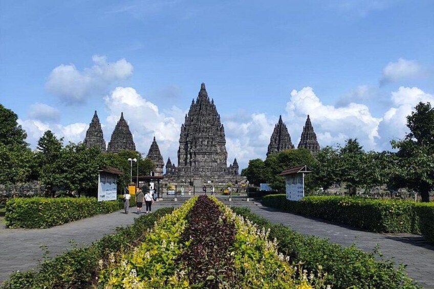A temple complex with multiple spires, surrounded by well-maintained gardens and pathways. 3